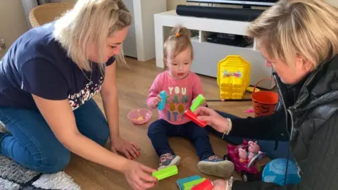 Ian Barmer/BBC Natalia, one-year-old Chloe and Kirsty Massie