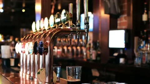 Getty Images Classic bar with bar counter and beer taps