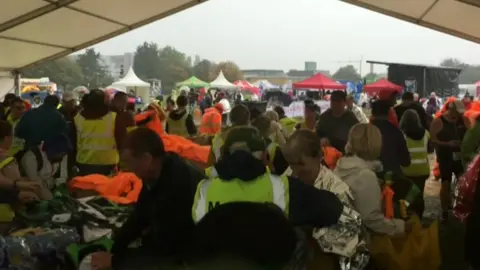 Runners taking shelter in marquee