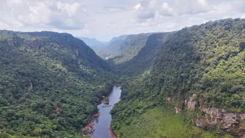 Getty Images Aerial view of the Potaro River near Kaieteur, the world's largest single drop waterfall, located in the Potaro-Siparuni region of Guyana, on April 12, 2023. The Kaieteur National Park is part of Essequibo, an oil-rich disputed area of 160,000 square kilometers that is administered by Guyana but which Venezuelans voted to claim as theirs in a referendum.