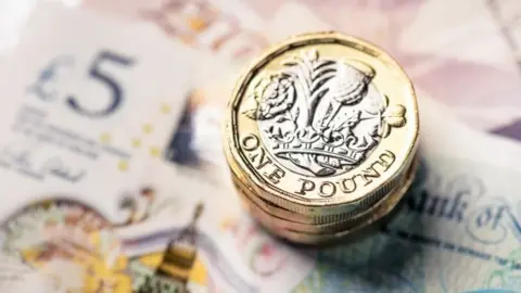 Getty Images Coins and cash