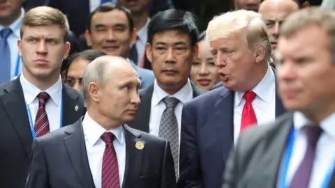 Reuters Russian President Vladimir Putin chats to Donald Trump at Apec summit on 11 November