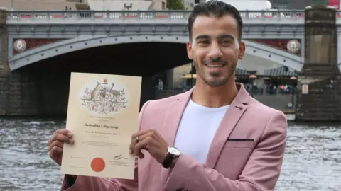 Getty Images Hakeem al-Araibi holding his Australian citizenship certificate (Melbourne, 12 March)