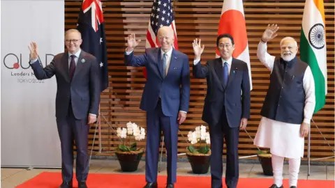Getty Images Australian Prime Minister Anthony Albanese, US President Joe Biden, Japanese Prime Minister Fumio Kishida, and Indian Prime Minister Narendra Modi wave to the media prior to the Quad meeting at the Kishida's office in Tokyo on May 24, 2022.