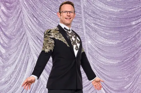 Ray Burmiston/BBC Jody Cundy in an embellished black jacket against a purple curtain