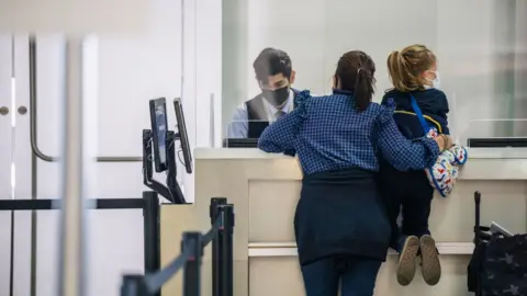 Getty Images Mother with daughter at airport