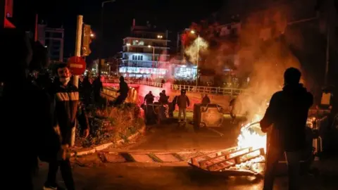 Reuters A fire is seen, as protesters clash with police officers during a demonstration