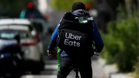 Reuters A deliveryman for Uber Eats rides a bike in Paris during a lockdown imposed to slow the spread of the coronavirus disease (COVID-19) in France, France, April, 1, 2020.