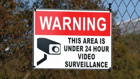 Getty Images Sign warning areas is under 24 hour video surveillance