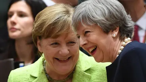 AFP German Chancellor Angela Merkel (L) and UK Prime Minister Theresa May (R) at EU leaders summit in Brussels, on 22 June 2017