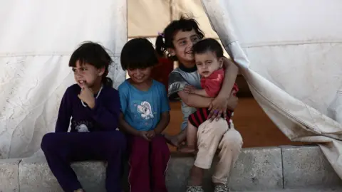 Getty Images Children at a camp for the displaced in the rebel-held Syrian province of Idlib on 2 September 2018