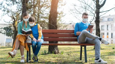 Getty Images people on a park bench