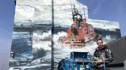 RNLI/Tom Collins Lewis Hobson and his mural