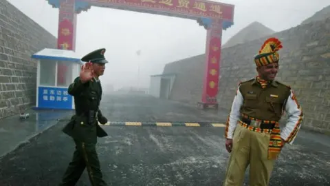 AFP A Chinese soldier and an Indian soldier stand guard at the Chinese side of the ancient Nathu La border crossing between India and China in 2008