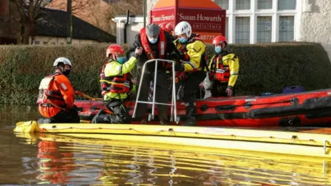 Reuters Rescuers helping a man