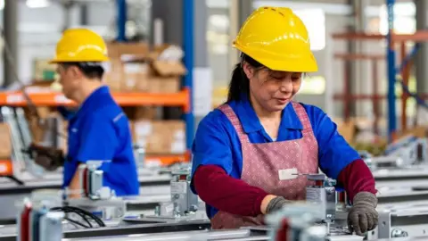 Getty Images A worker makes lift parts at a workshop in Hai 'an, Jiangsu Province, China.