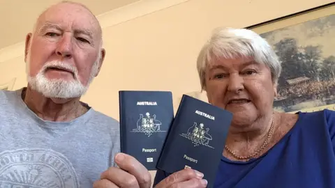 JOHN AND MARGARET SPARKS John and Margaret Sparks hold up their Australian passports