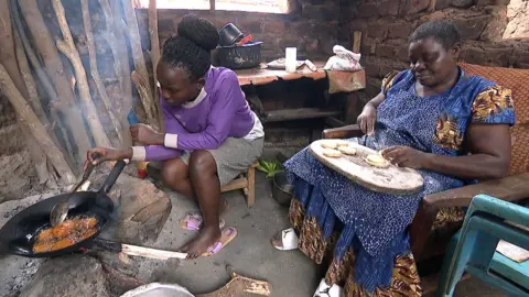 Joyce Namugalu Mutasiga making pancakes