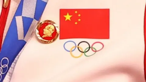 Reuters A Chinese cyclist wears a Mao badge during a medal ceremony at the Olympics