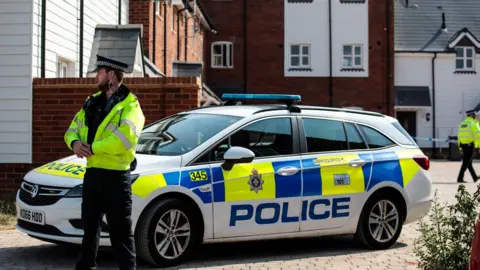 Getty Images Police on the scene at Muggleton Road where a major incident was declared after a man and woman were exposed to the Novichok nerve agent