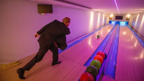 SWNS Graham Wildin bowling inside his complex