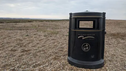 National Trust/PA Media A bin on a beach