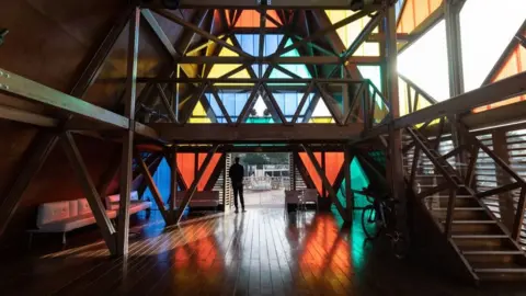 Queila Fernandes/AFP A man stands at the entrance to the Mansa Floating Hub in Mindeko, Sao Vicente on October 4, 2023.