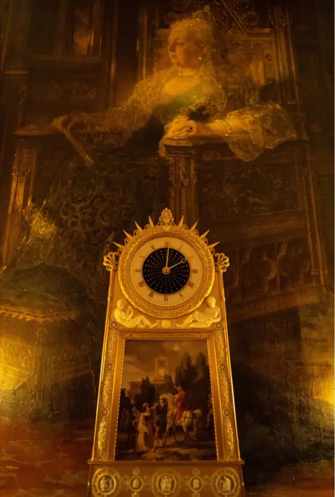 Antonio Olmos A beautiful clock with a large portrait of Queen Victoria behind it