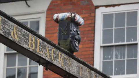 Reuters Sign above The Green Man and Black's Head Hotel