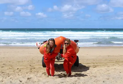 Juliette Letort Women pull a lifeboat up the beach