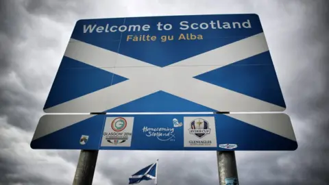 Getty Images A Scottish Saltire flag flies on the border with England on September 14, 2014 in Carter Bar, Scotland