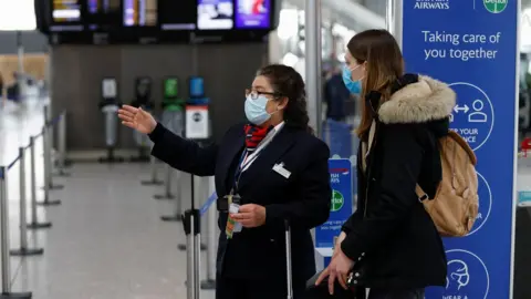 Reuters Passenger and staff at Heathrow Airport