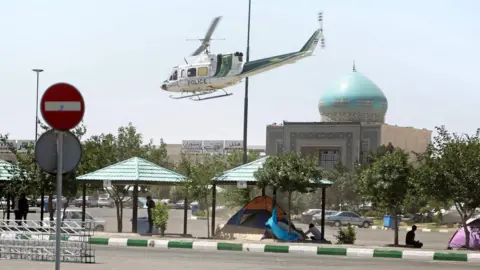 AFP A police helicopter flies near the the mausoleum of Ayatollah Ruhollah Khomeini in Tehran, Iran (7 June 2017)