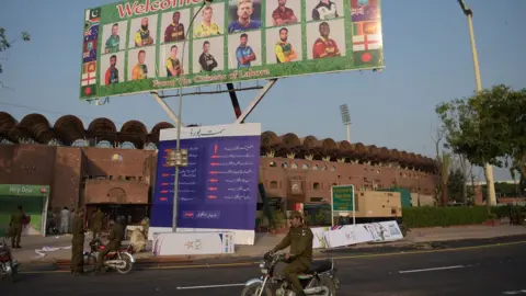 AFP Pakistani policemen ride past a billboard featuring International World XI cricketers displaying outside the Gaddafi Cricket Stadium in Lahore on 10 September 2017