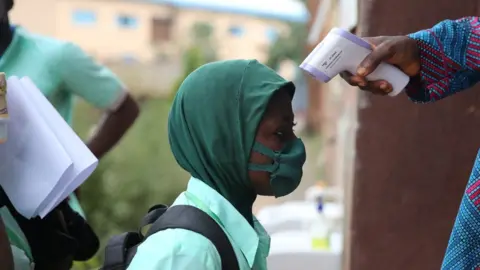 EPA Schoolgirl having her temperature taken