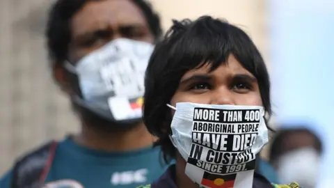 Getty Images Protesters march in solidarity with protests in the United States in Adelaide, Australia