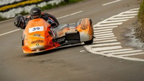 ISLE OF MAN TT RACES Cesar Chanal and Olivier Lavorel in a sidecar