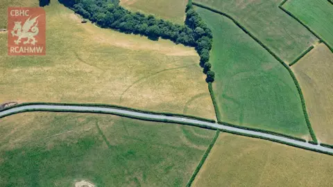 RCAHMW Iron Age farmstead Whitland seen with a modern road running through it