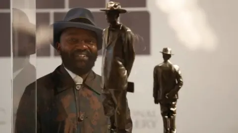 Reuters Samson Kambalu stands in front of his design for the Fourth Plinth