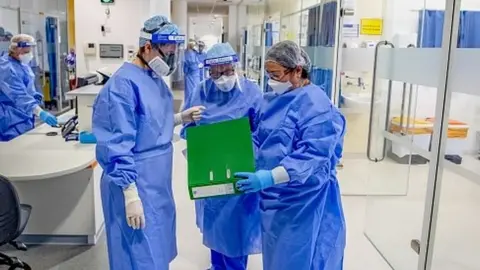 PA Media NHS staff in PPE