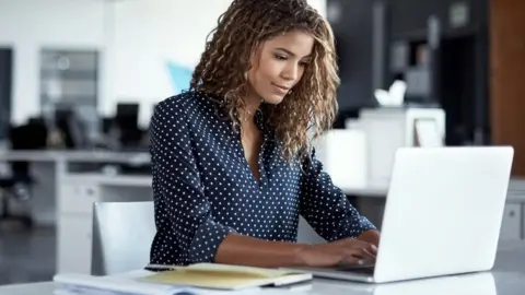 Getty Images Woman working in an office