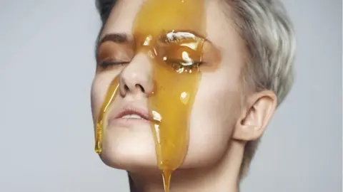 Getty Images A woman with honey on her face