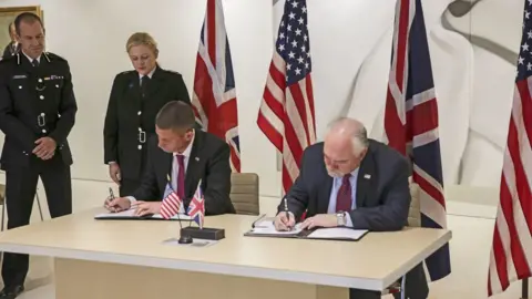 US Embassy, PA Joint proclamation on efforts to tackle FGM being signed by the NPCC's Ivan Balhatchet and Louis Rodi (right) from US Homeland Security Investigations