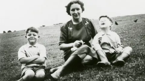 MPL Communications Inc/Ltd Paul McCartney with brother Mike and mum Mary, late 1940s