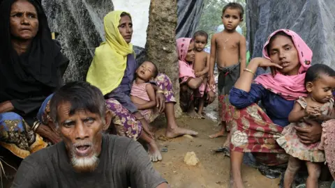 EPA Rohingya women sit in front of their makeshift shelters in a camp in Ukhiya, Cox's Bazar, Bangladesh, 11 September 2017