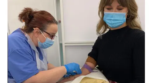 Georgia and a nurse giving her a check-up Georgia Pullen