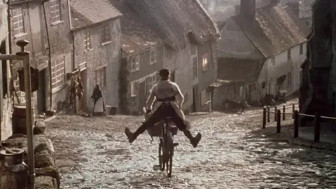 Hovis A young Carl Barlow freewheels down the street cobbled street