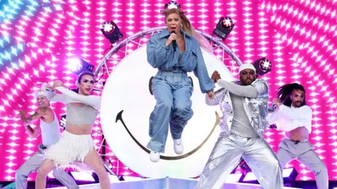 Simone Joyner/Getty Images Becky Hill and dancers performing live during Reading Festival 2023