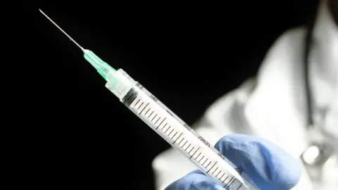 Getty Images File photo: Doctor holding medical injection syringe