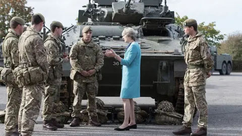 Getty Images Theresa May talking to soldiers